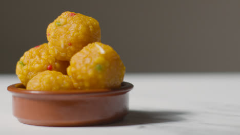 Close-Up-Of-Laddoo-In-Bowl-Celebrating-Muslim-Festival-Of-Eid